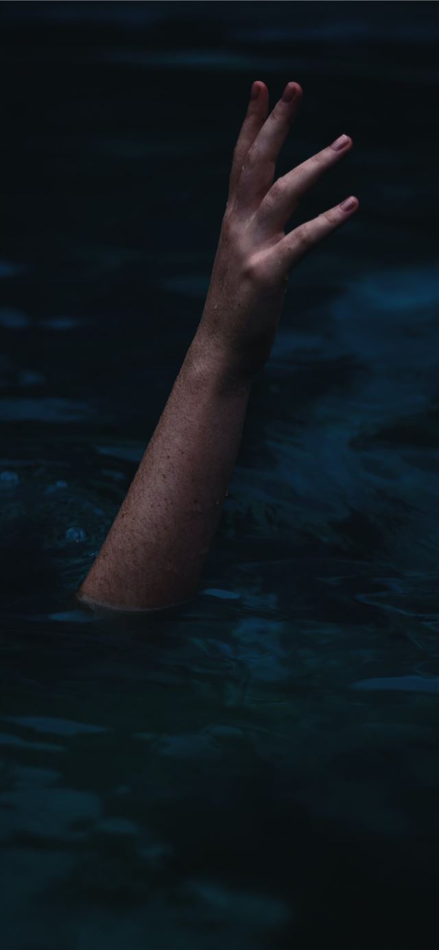 person showing right hand from body of water iPhone 12 wallpaper 