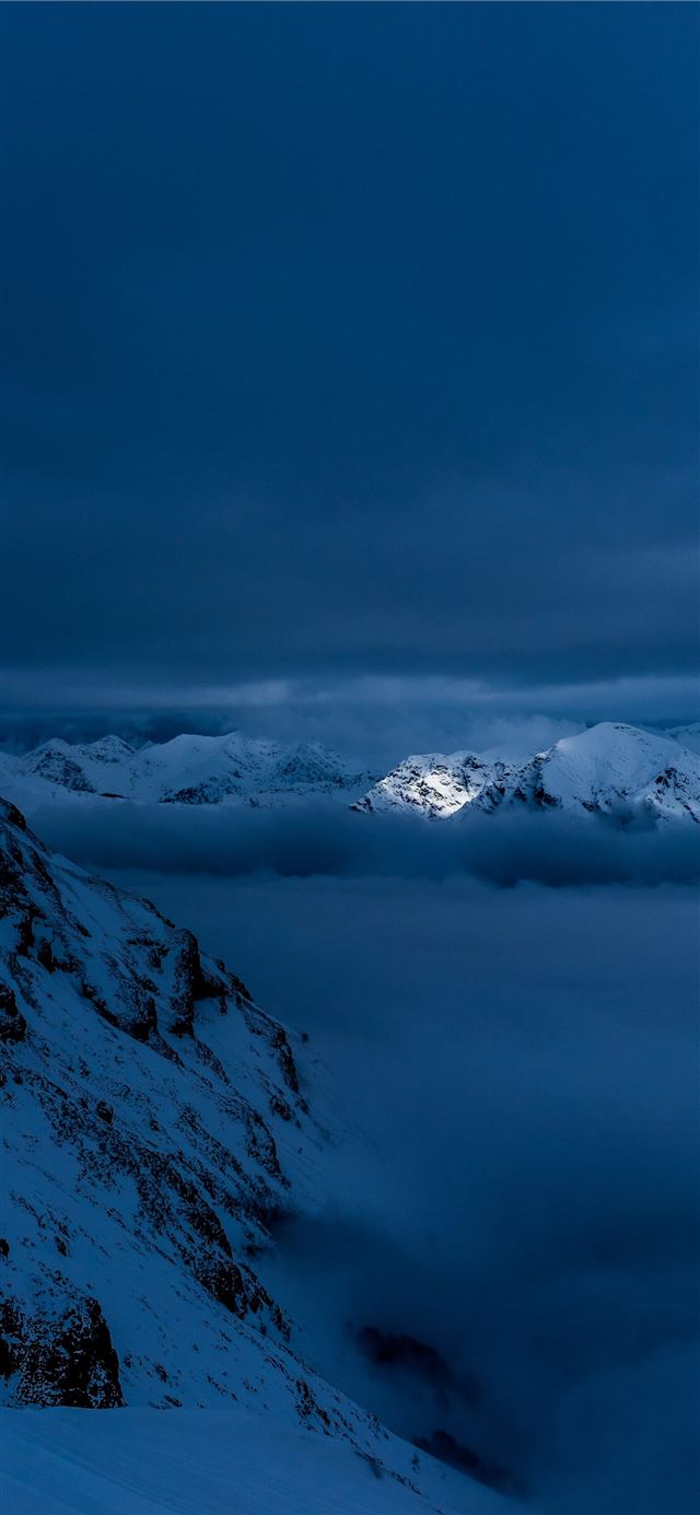 snow capped mountain covered in clouds iPhone 12 wallpaper 