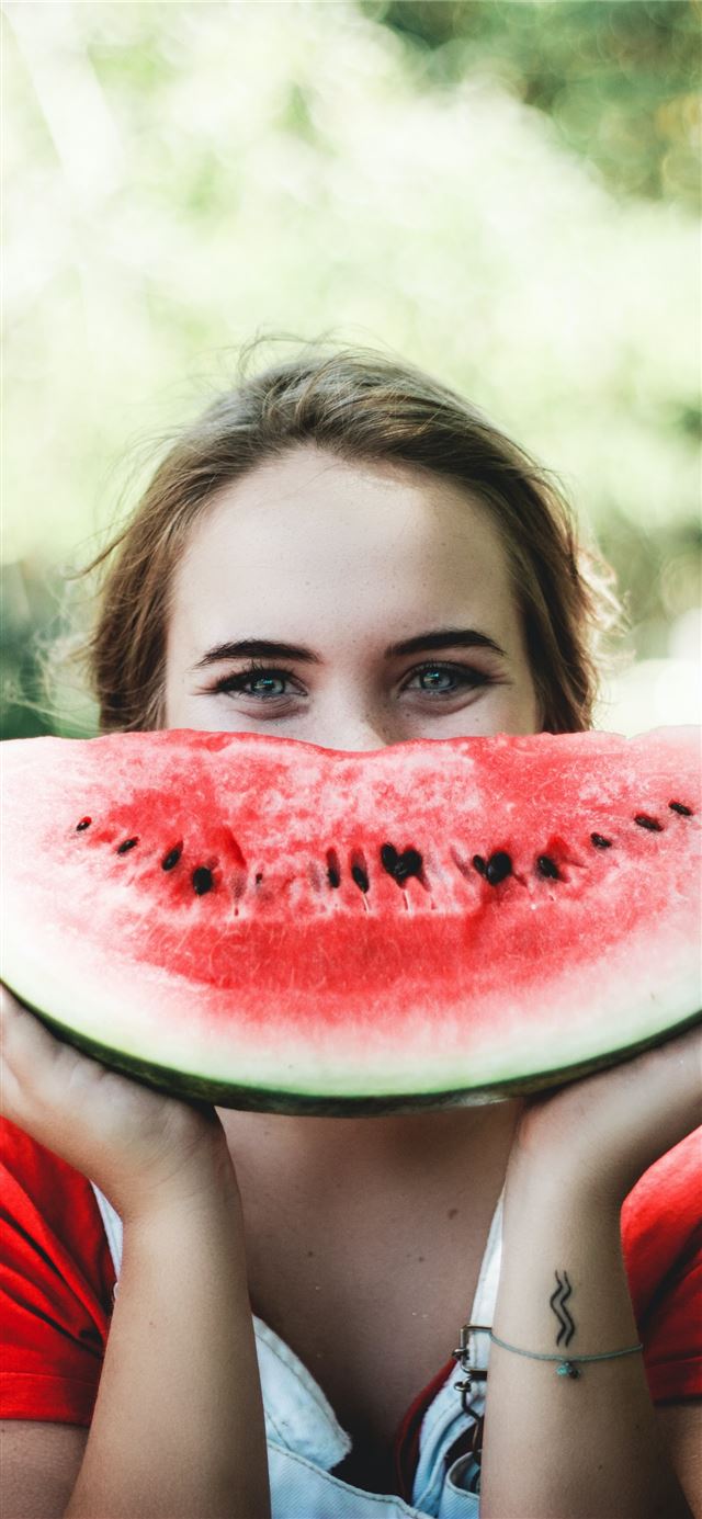 woman holding sliced watermelon iPhone 12 wallpaper 