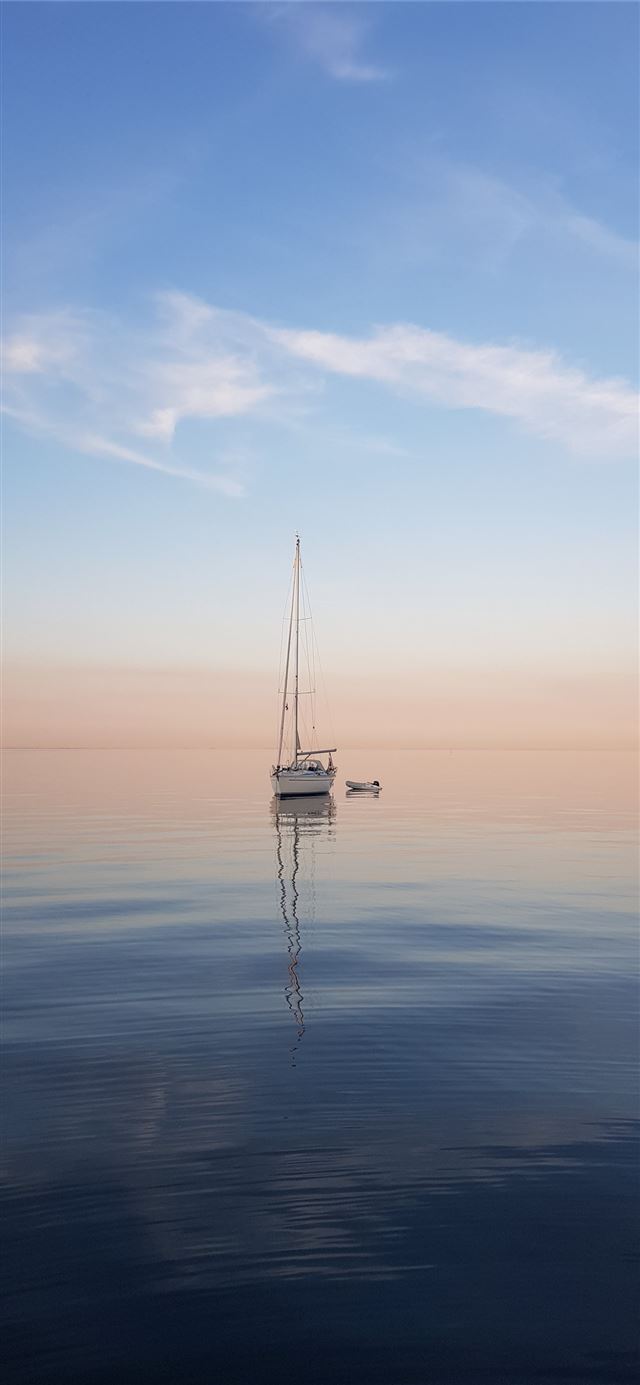 white sailboat at middle of sea iPhone 12 wallpaper 