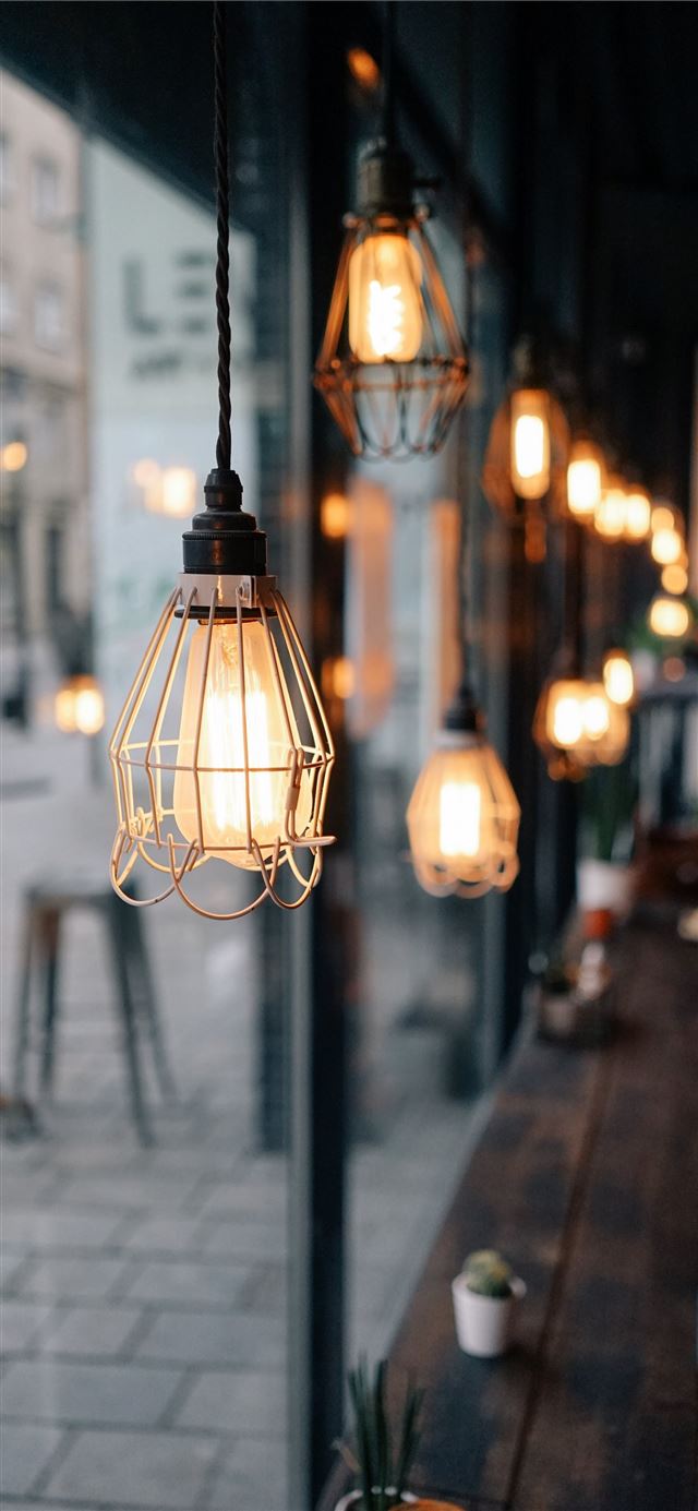 shallow focus photography of store pendant lamps iPhone 12 wallpaper 