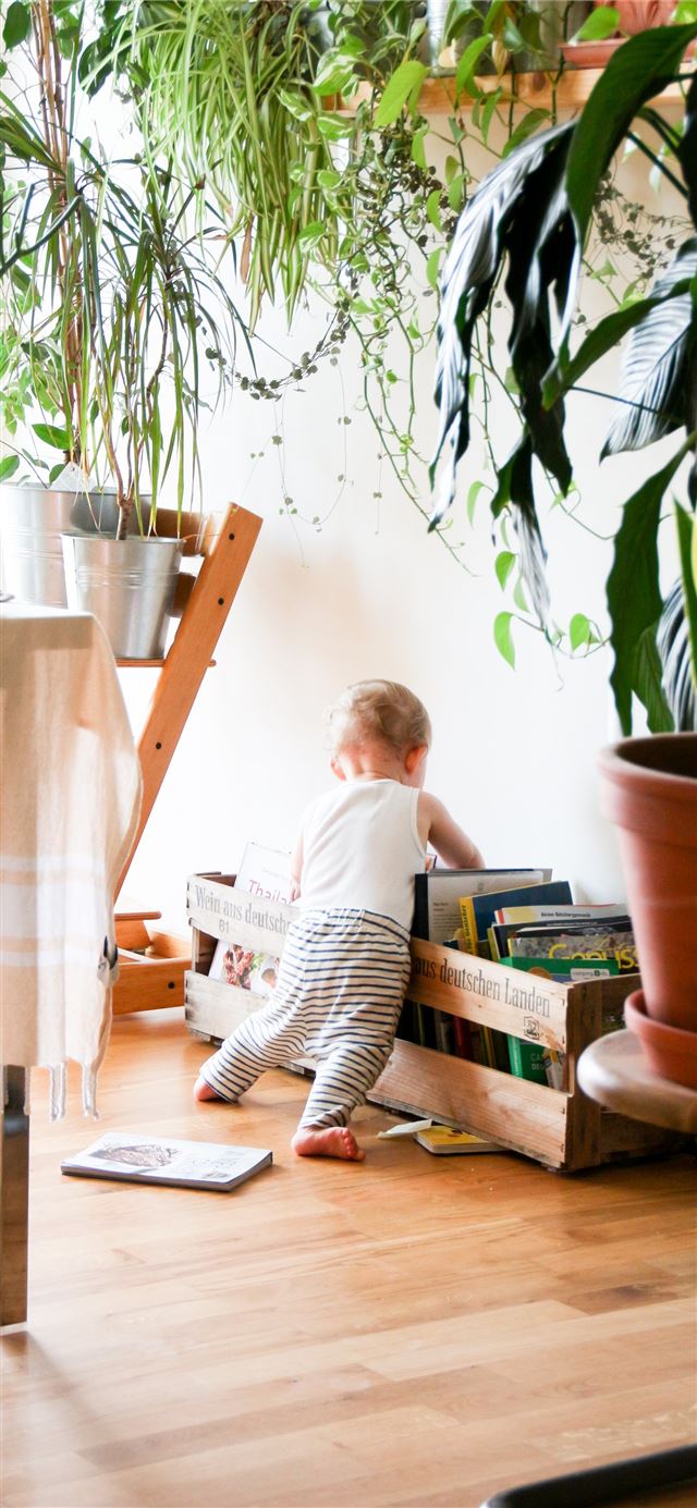 toddler wearing white tank top near white wall iPhone 12 wallpaper 