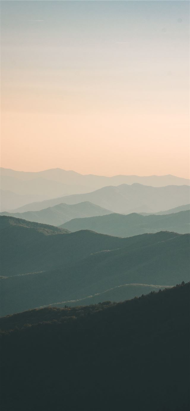 mountains under white mist at daytime iPhone 12 wallpaper 