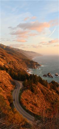 bird's eye photography of road near ocean wallpaper