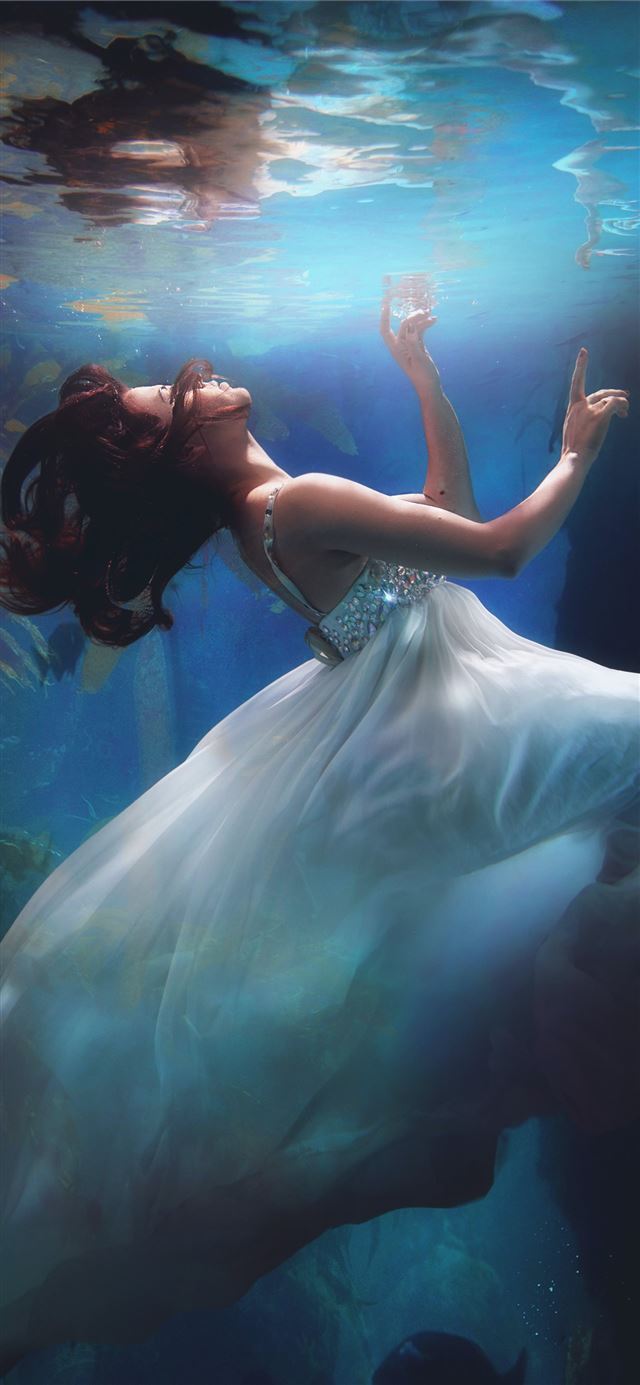 underwater photography of woman wearing white dres... iPhone 12 wallpaper 