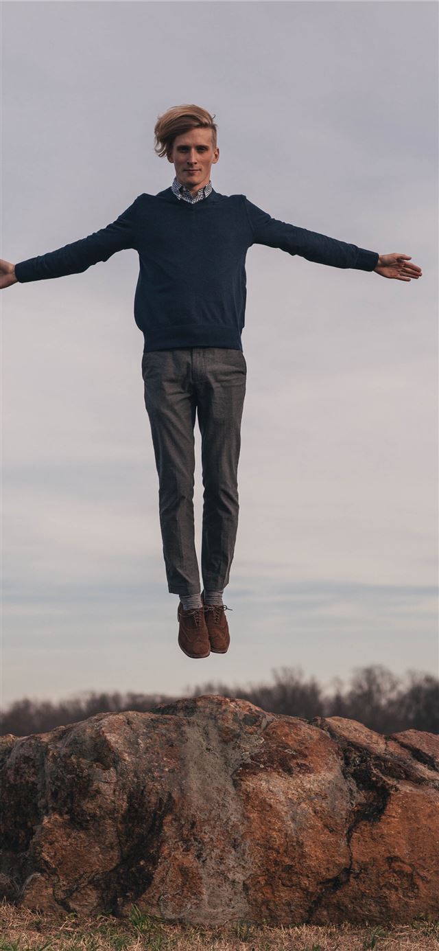 man jumping while open arms iPhone 12 wallpaper 
