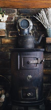 cast iron teapot on wood burner wallpaper