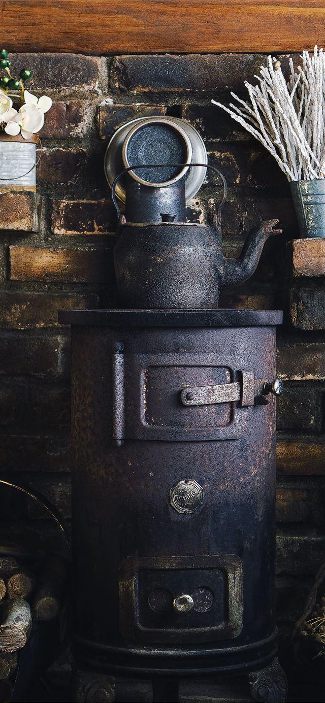 cast iron teapot on wood burner iPhone 12 wallpaper 