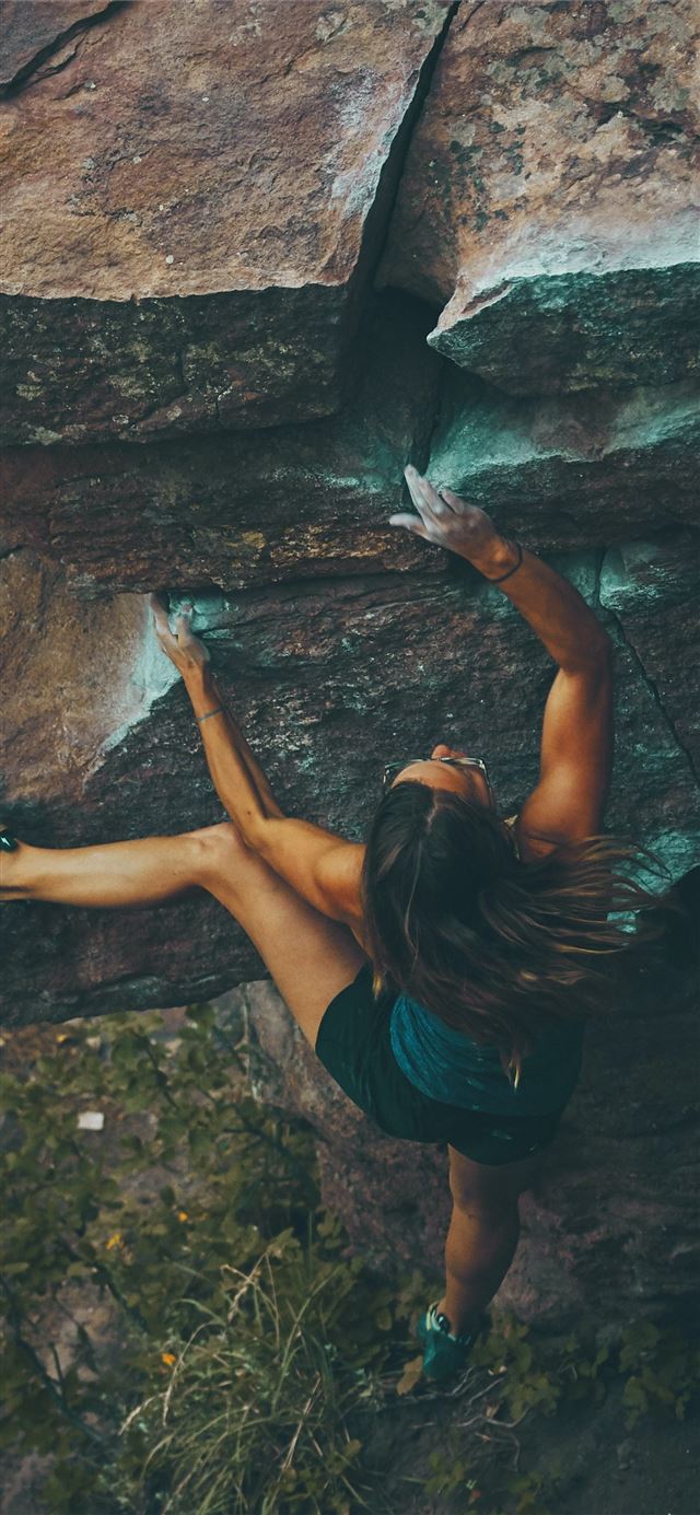 photo of woman climbing mountain iPhone 12 wallpaper 