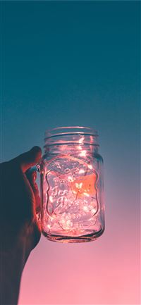 person holding clear glass mug jar wallpaper