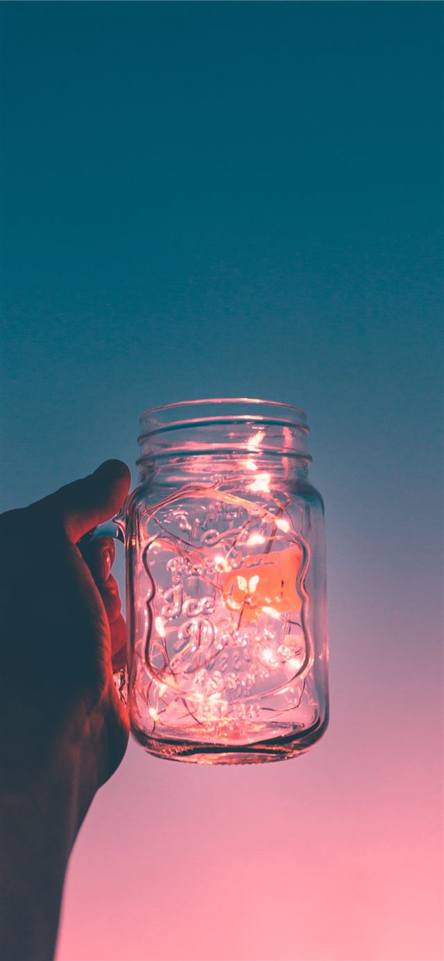 person holding clear glass mug jar iPhone 12 wallpaper 