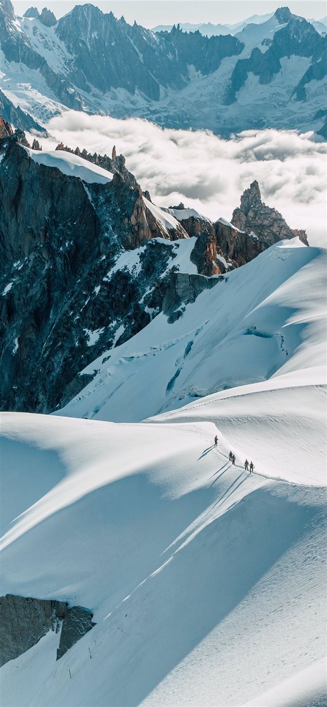 people on ridge covered with snow iPhone 12 wallpaper 