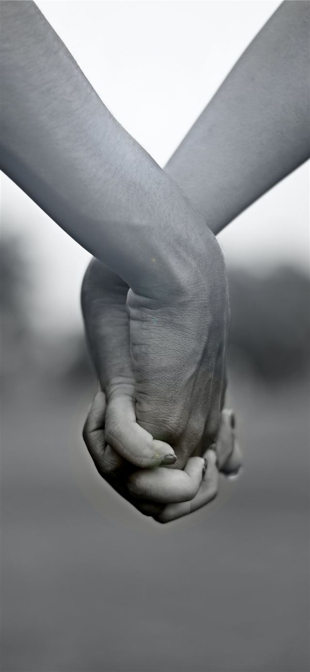 grayscale photo of two person holding hands iPhone 12 wallpaper 