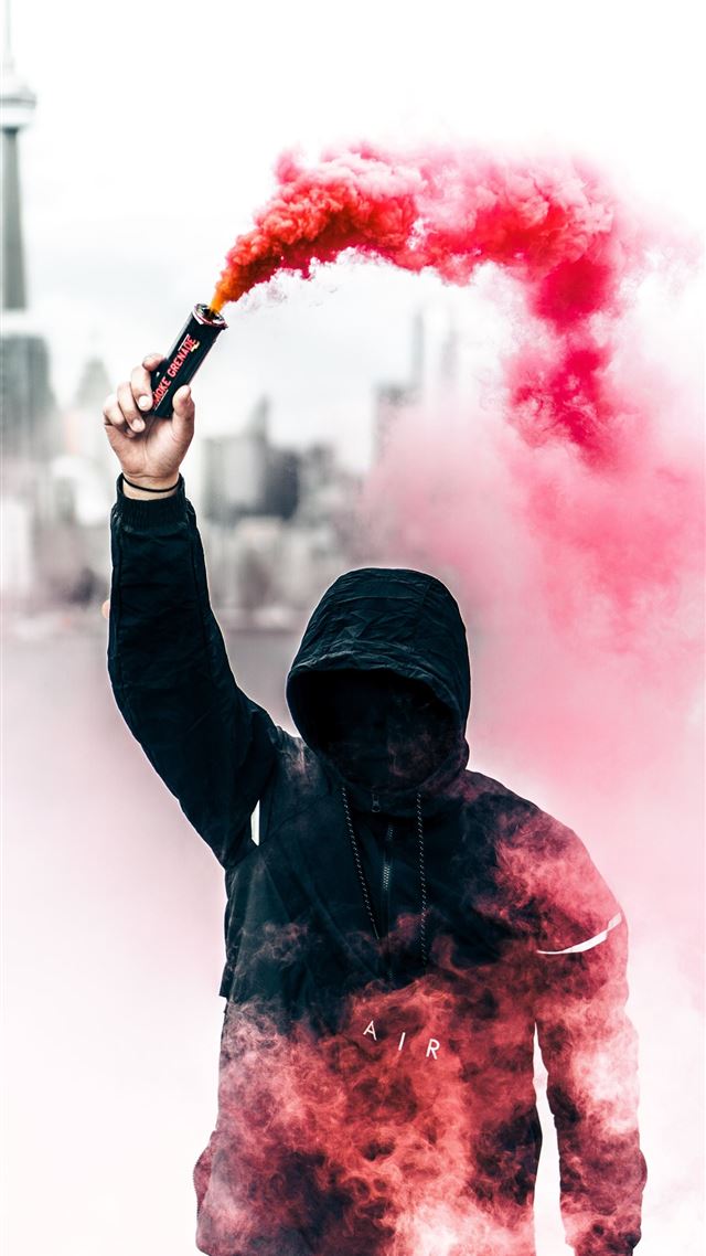 1080x1920 person wearing black and red hoodie holding smoke ... - canada iPhone 8 Wallpaper