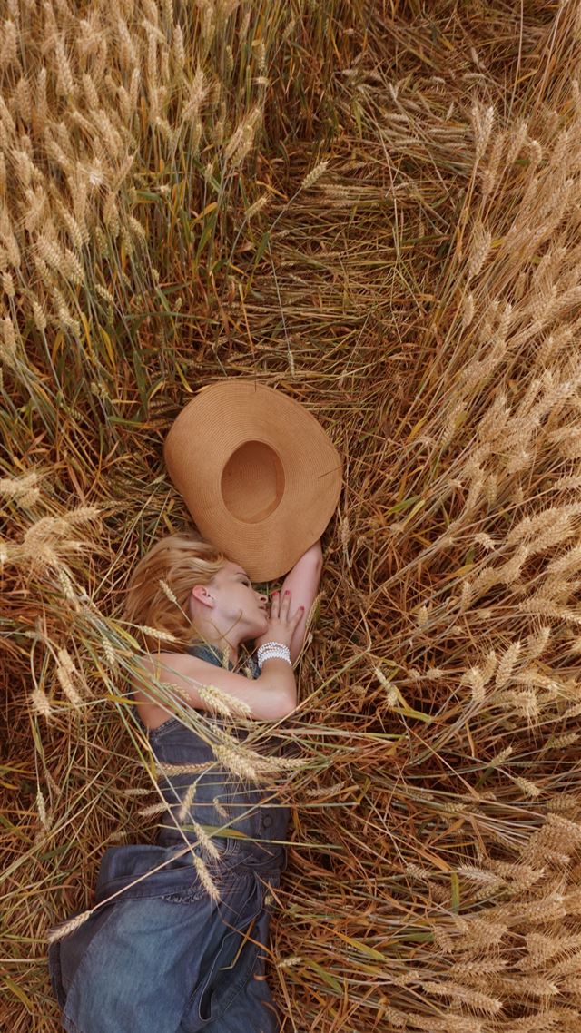 1080x1920 woman lying on wheat field - brown iPhone 8 Wallpaper
