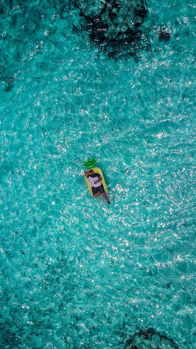 1080x1920 top view photography of man in float on sea - water iPhone 8 Wallpaper