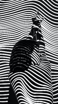 woman raising both arms with stripe light color wallpaper