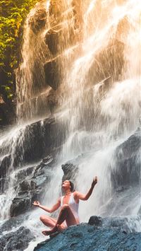 woman in white monokini sitting on rock wallpaper