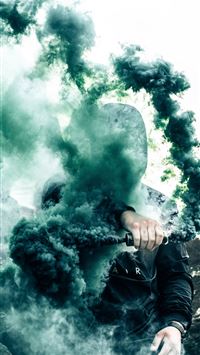 person holding gas grenade wallpaper