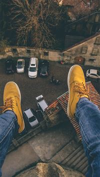 person sitting on rooftop wallpaper