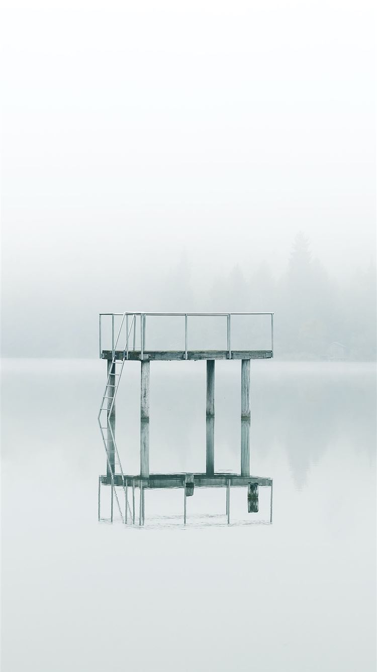photography gray metal tower near body of water du... iPhone 8 wallpaper 