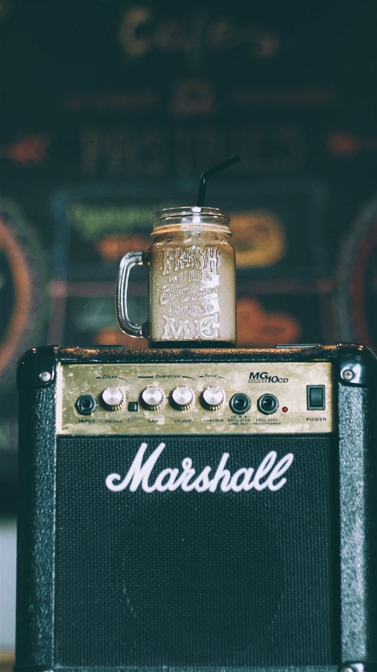 black Marshall guitar amplifier with glass mug on ... iPhone 8 wallpaper 
