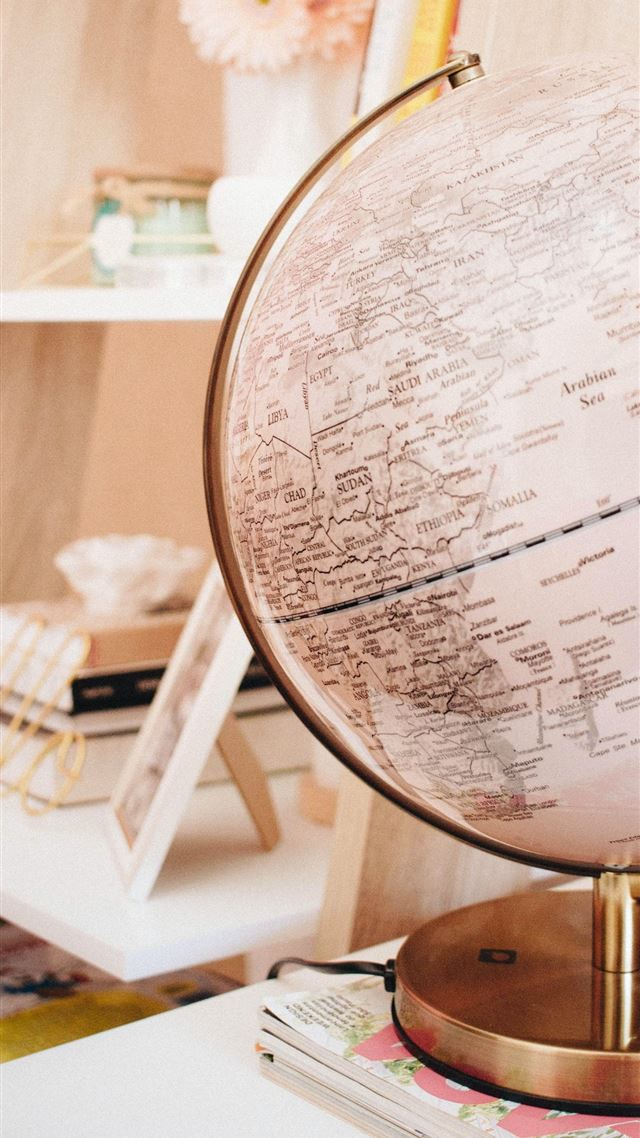 1080x1920 white and black desk globe on the top of magazines - pink iPhone 8 Wallpaper