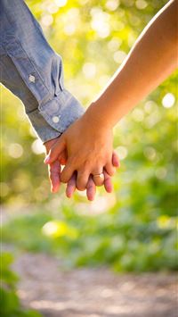 shallow focus photo of man and woman holding hands wallpaper