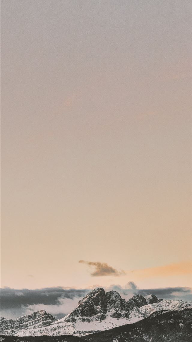 1284x2778 rock formation coated with snow under orange sky - dolomites iPhone 8 Wallpaper