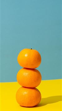 orange fruit on yellow surface wallpaper