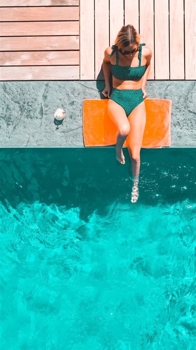 1284x2778 woman lying beside swimming pool during daytime -  iPhone 8 Wallpaper