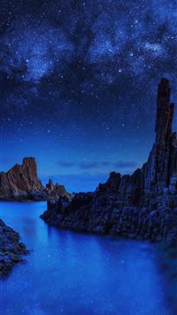 ocean rocks on starry night 4k wallpaper
