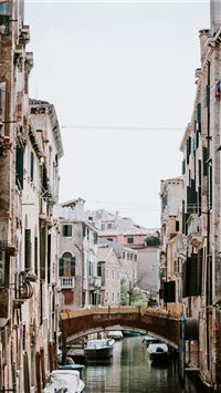Laundry hanging over Venetian canal and bridge wallpaper