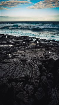 Dusk over a field of lava bordering the Pacific Oc... wallpaper