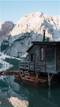 A house in the lake with a few boats wallpaper