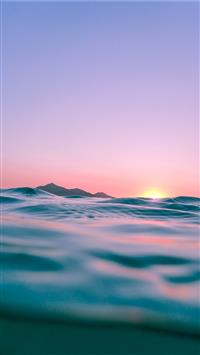 calm body of water during golden hour wallpaper