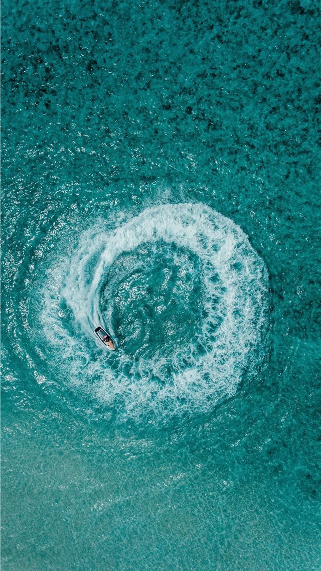 1080x1920 aerial shot person riding on personal watercraft - ocean iPhone 8 Wallpaper