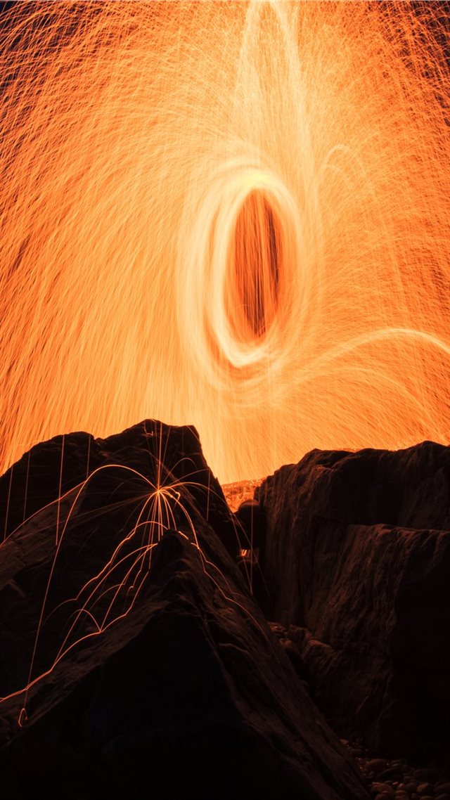 1080x1920 steel wool photography of brown rock formations - orange iPhone 8 Wallpaper