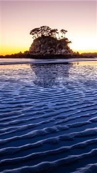 trees on top of hill in islet wallpaper