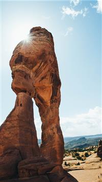 brown boulder near canyon under blue sky wallpaper