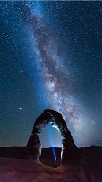 natural arch viewing milky way during night time wallpaper