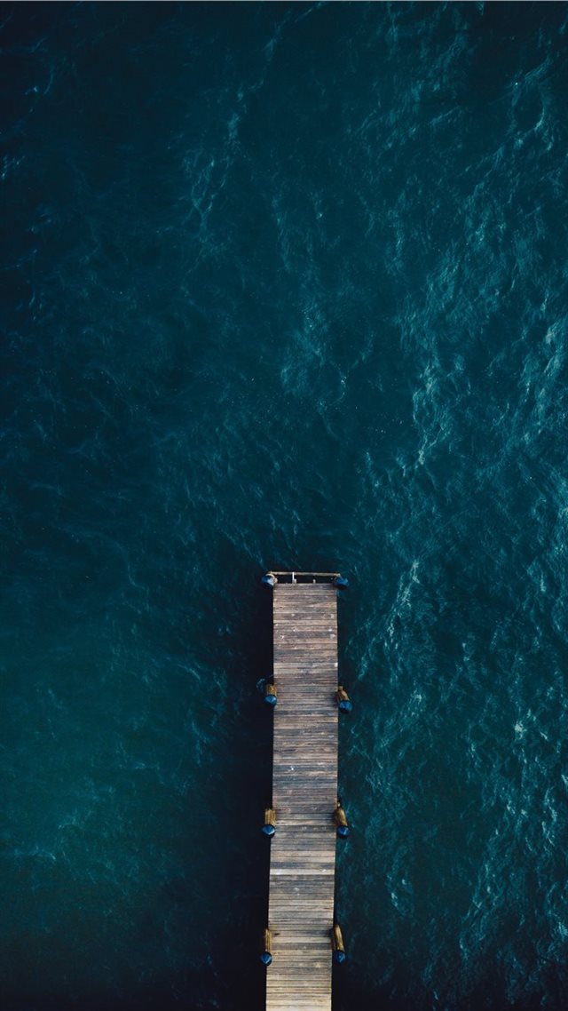 1080x1920 brown wooden bridge on body of water - ocean iPhone 8 Wallpaper