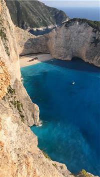 rock formation near body of water wallpaper