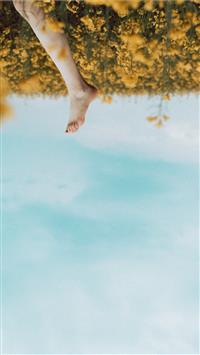 person's foot in a yellow flower field during dayt... wallpaper