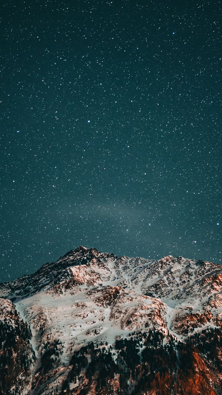 snow covered mountain under starry night iPhone 8 wallpaper 