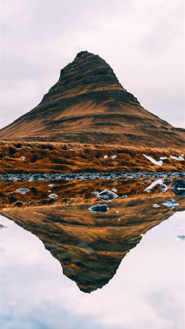 1080x1920 brown mountain under white clouds during daytime - water iPhone 8 Wallpaper