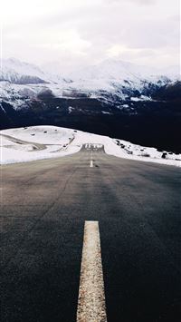 gray concrete road near snow covered mountain duri... wallpaper