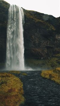 waterfalls surrounded by rocky mountains wallpaper