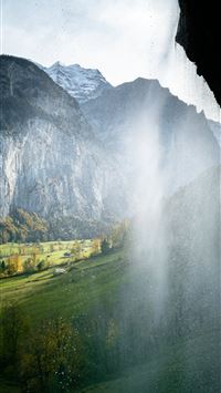 green grass field near mountain during daytime wallpaper