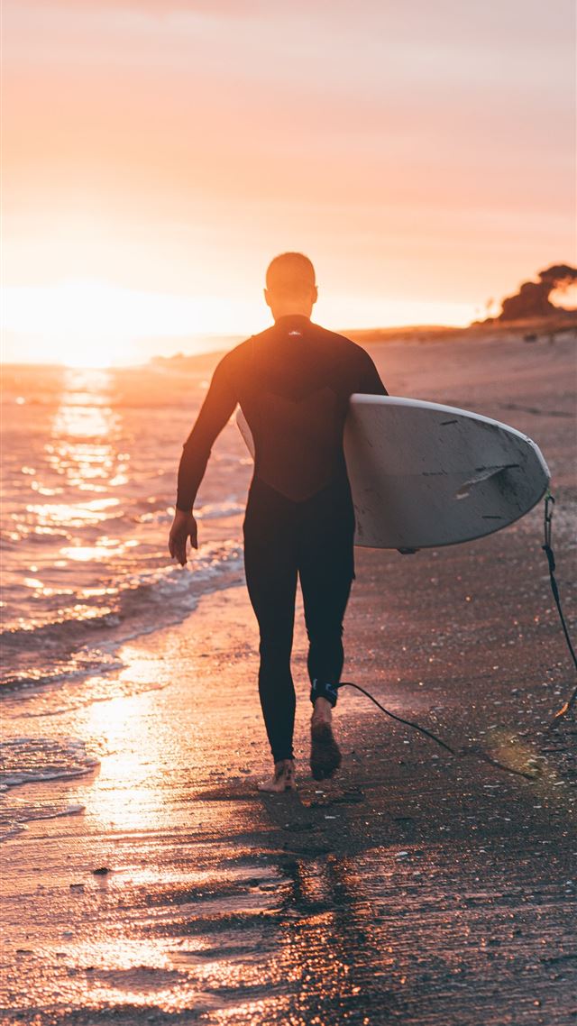 1080x1920 man holding white surfboard - new zealand iPhone 8 Wallpaper